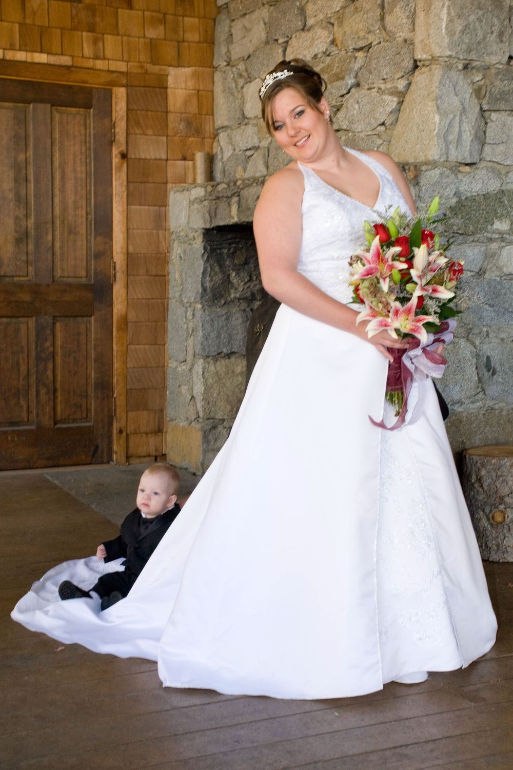 A series of wedding photos showing a bride in a white gown posing with a small child against a stone wall background.