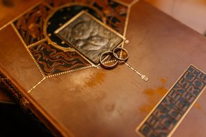 Vintage leather-bound books arranged on a rustic wooden surface with warm lighting.