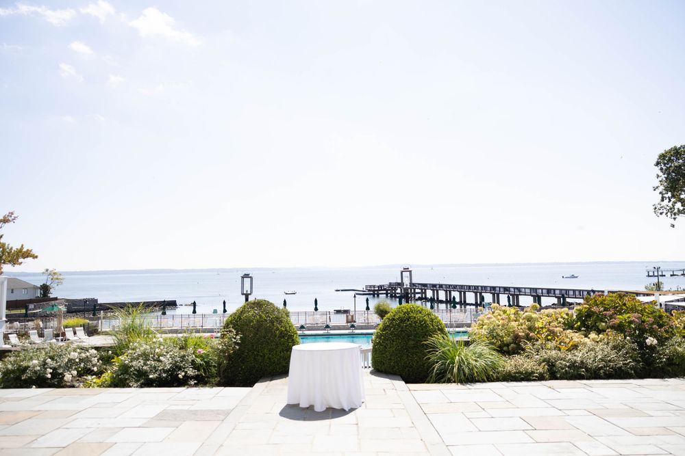 Scenic coastal view of a pier and landscaped garden overlooking the ocean on a bright sunny day.