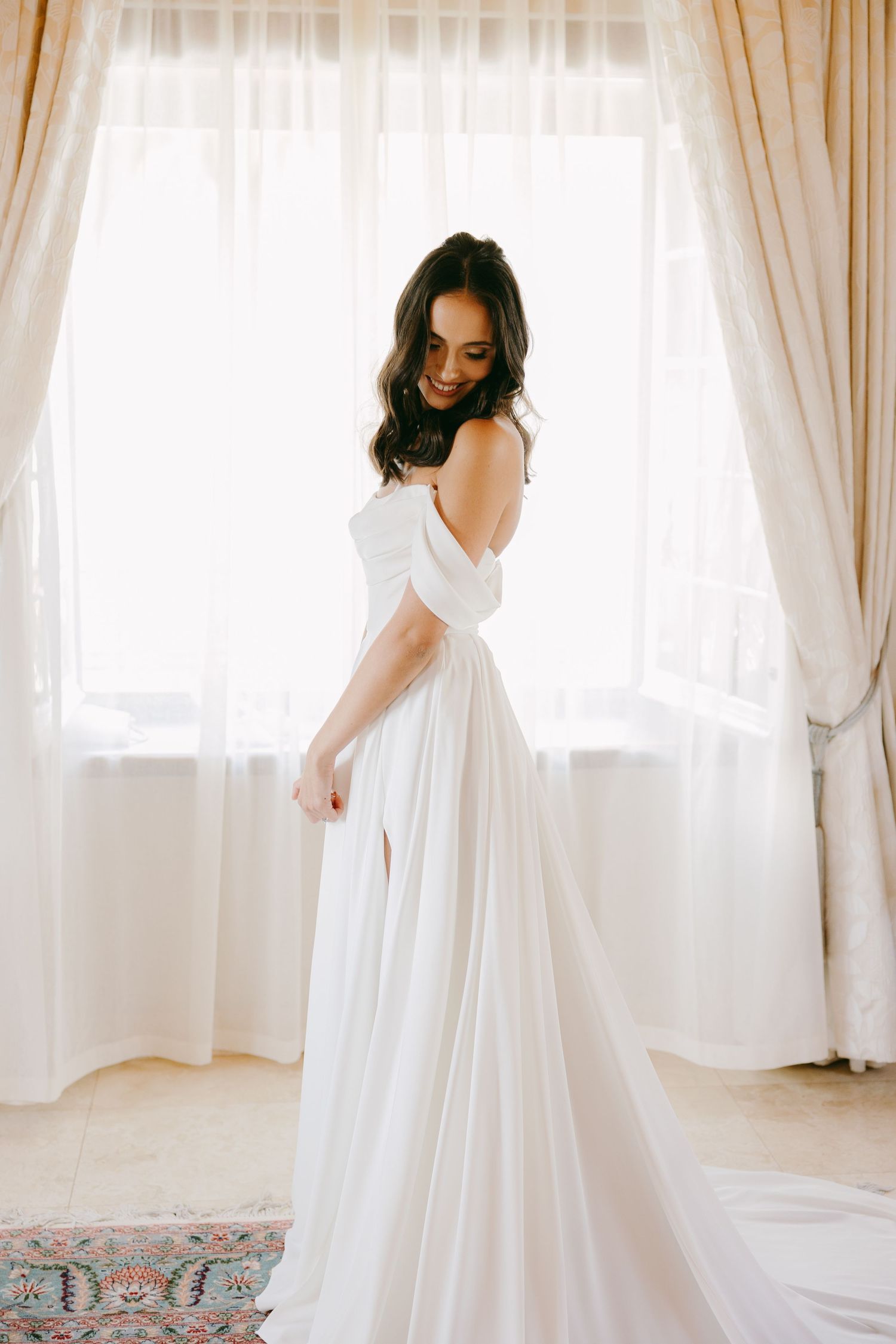 A series of photos showing a flowing white dress being twirled in a bright room with sheer curtains and decorative rug.