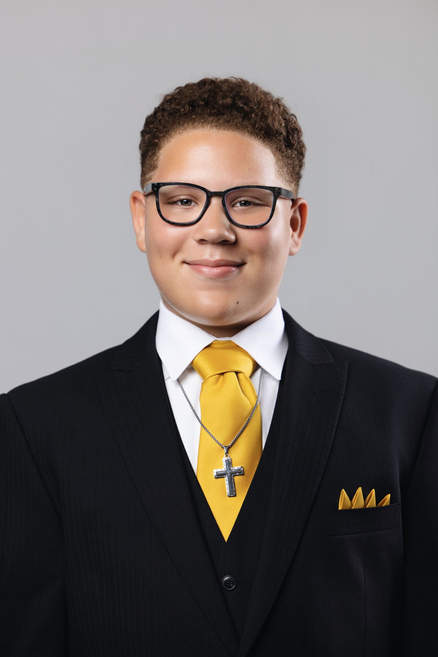 Professional portrait series showing black suit and yellow tie combinations with formal styling against gray background.