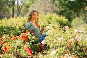 Joyful moment in a blooming garden with colorful red poppies and greenery.