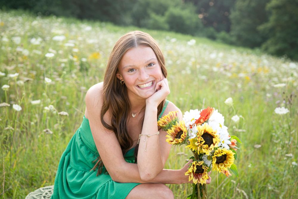 Series of outdoor portraits with sunflowers and green dress in a summer meadow.