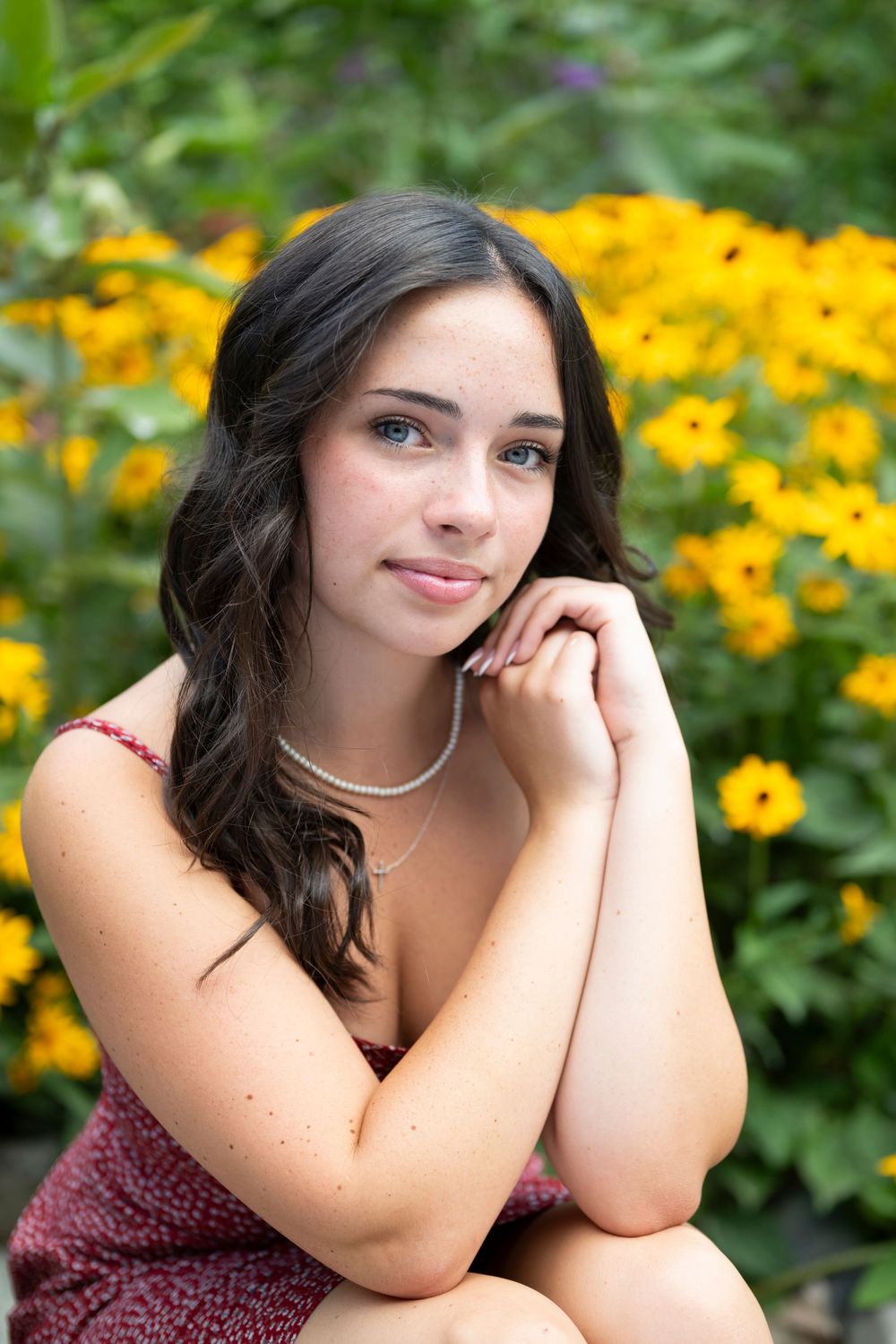 Portrait against vibrant yellow wildflowers in garden setting with natural lighting.