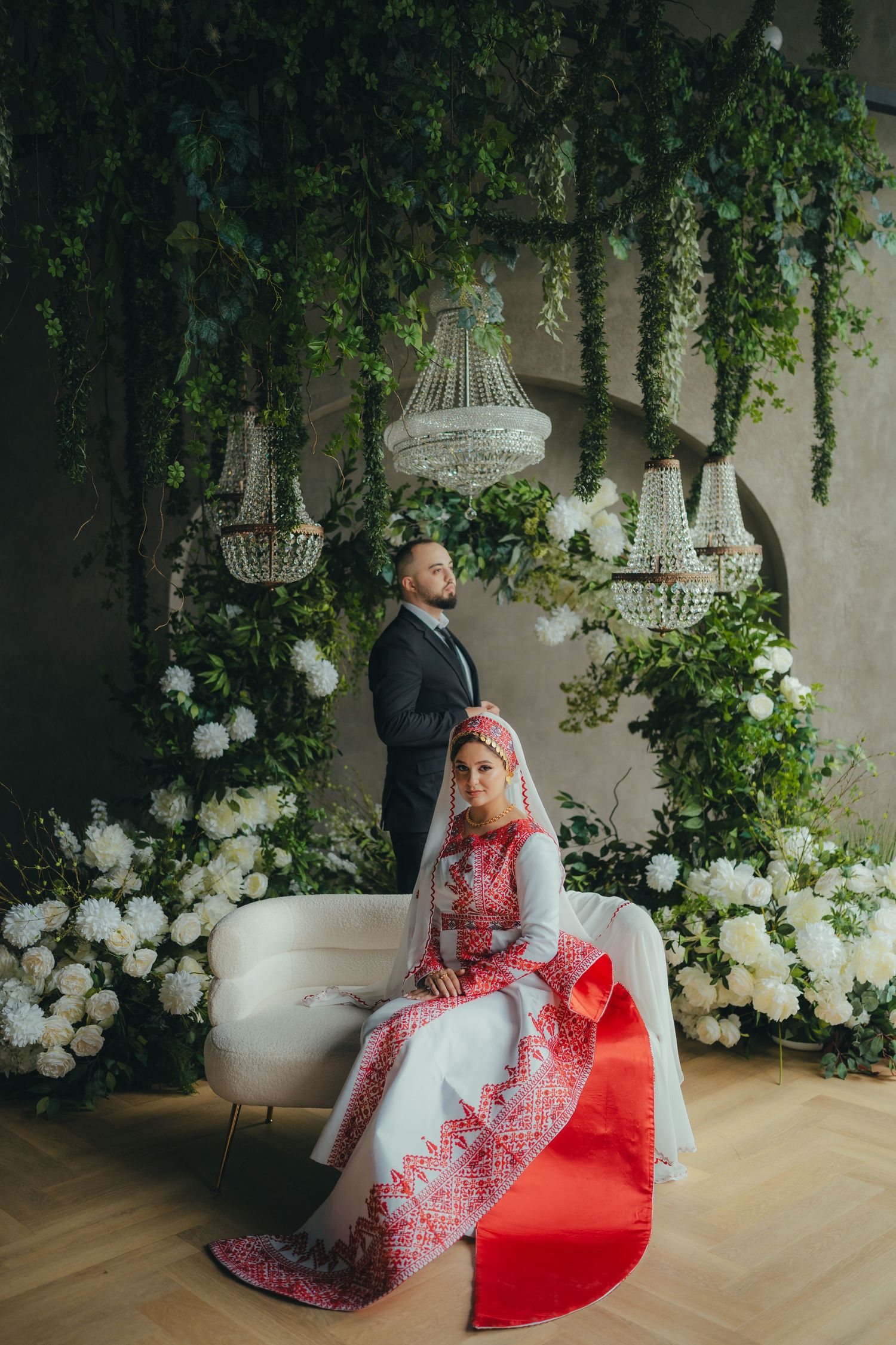 Modern wedding reception space with acrylic display stands and white candle arrangements.