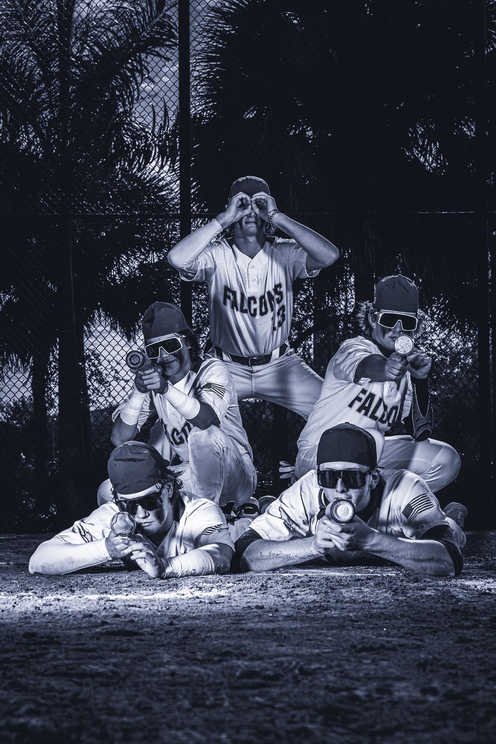 Baseball team poses with binoculars in playful formation wearing vintage-style uniforms.