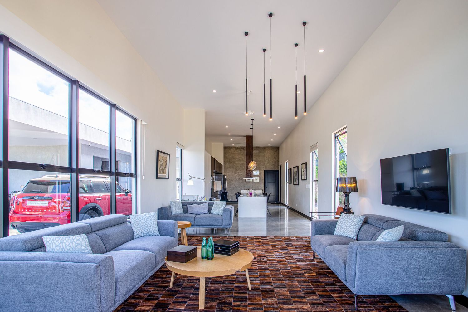 Modern  living room with open space.Spacious and contemporary dining area with large windows offering natural light and views of Costa Rican