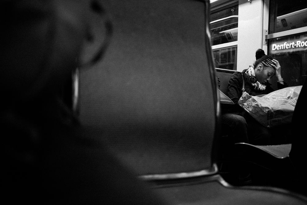 Blurred black and white photo of passengers on public transportation.