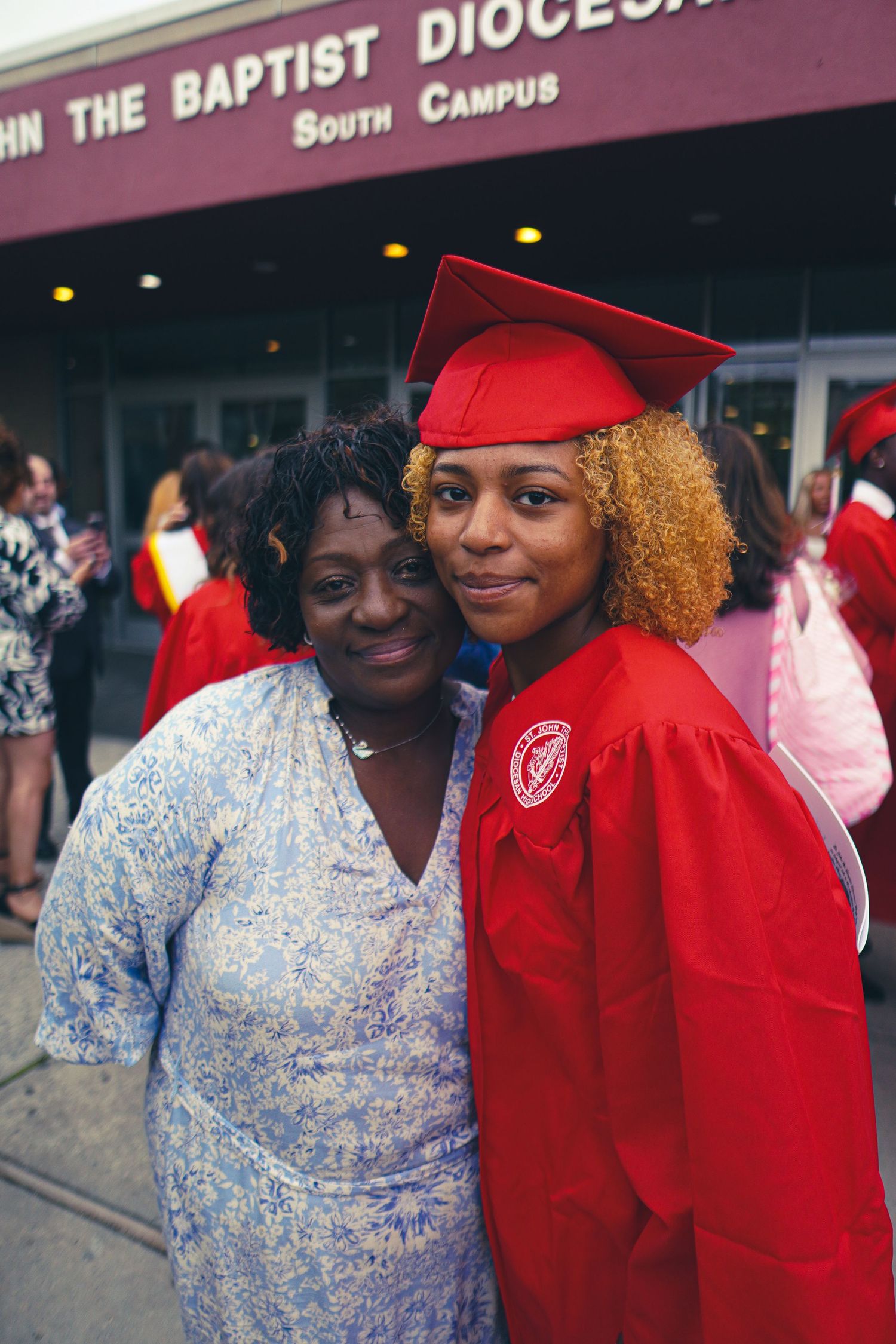 Graduation celebration outside John the Baptist Diocese South Campus building.