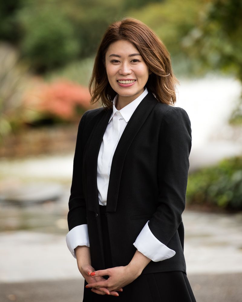 Corporate Professional smiling during a headshot session in Treasury Gardens in melbourne