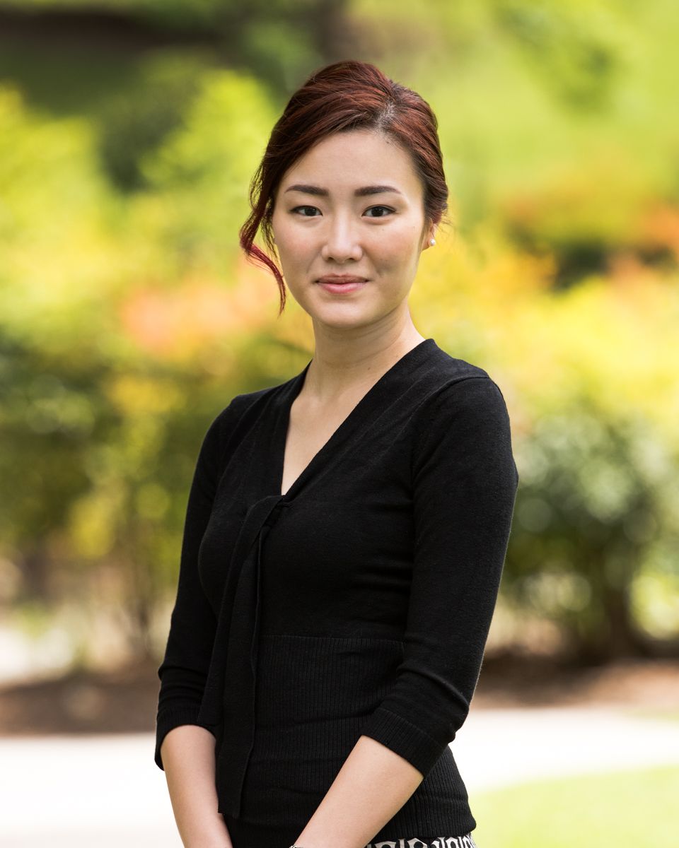 Corporate Professional smiling during a headshot session in Treasury Gardens in melbourne