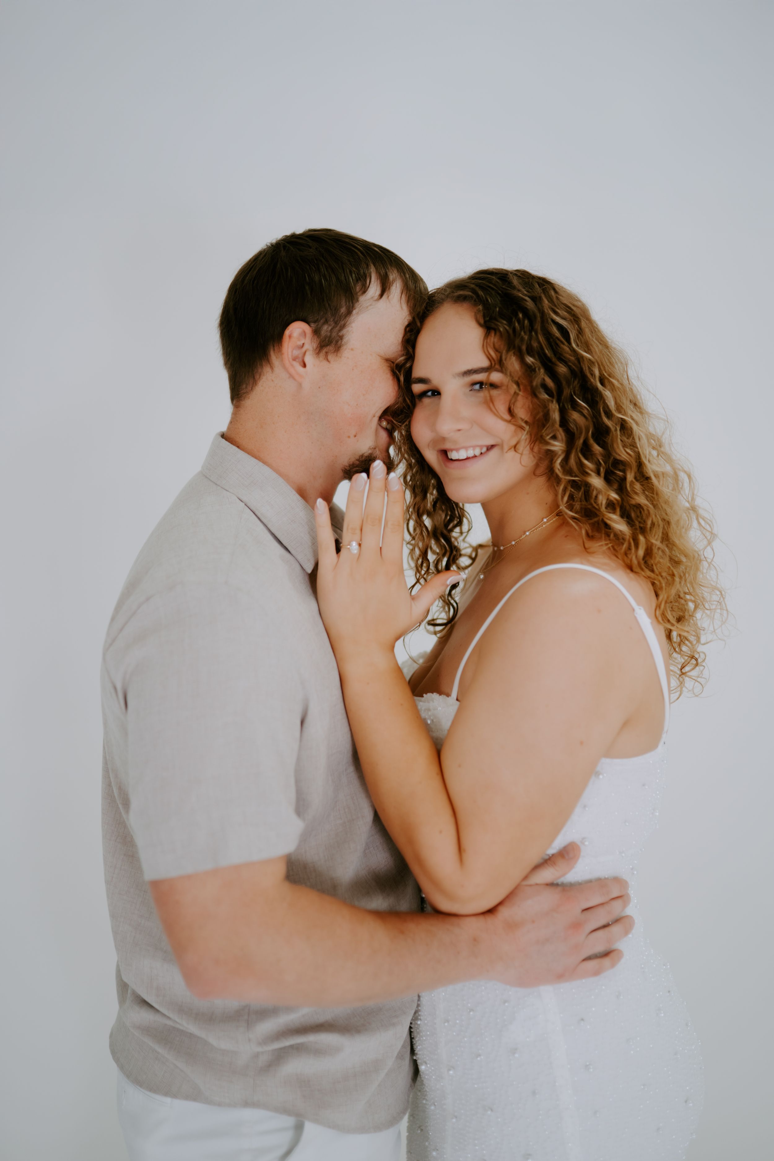 Romantic couple portrait series with soft lighting showing intimate expressions and gentle touches.