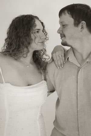 Black and white intimate portrait of couple gazing at each other with affection.