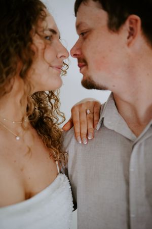 Artistic close-up portrait showing curly hair and gentle expressions in warm light.