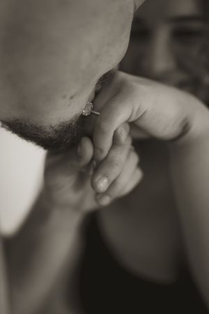Artistic black and white macro shot of hands and gentle touch.
