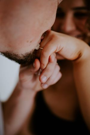 Close-up artistic photo showing gentle touch of hands in warm light.