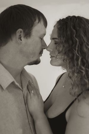 Black and white romantic portrait showing intimate moment between couple.