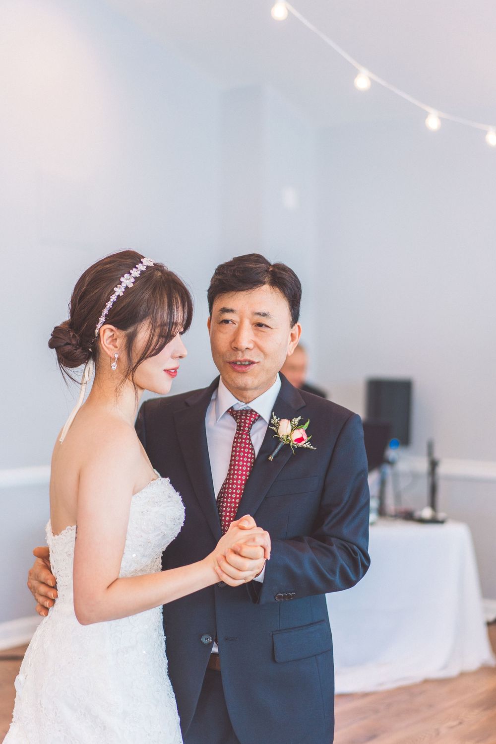 A wedding couple sharing their first dance in an elegant reception hall.