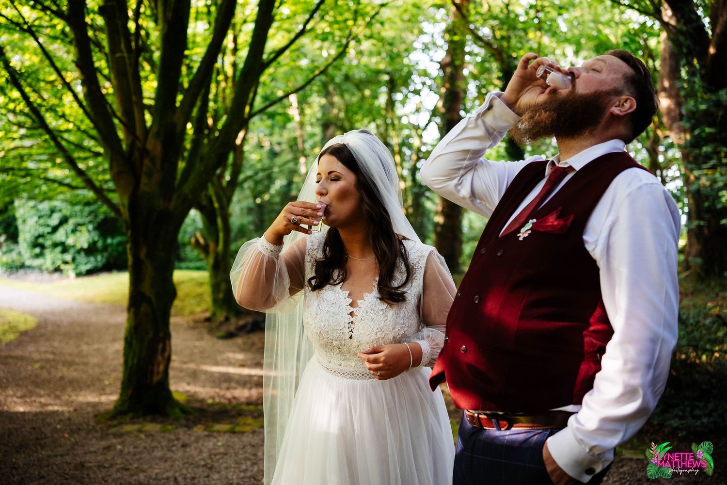 A bride & groom at bartle hall drinks shots of tequila rose together in the woods captured by lynette matthews photography