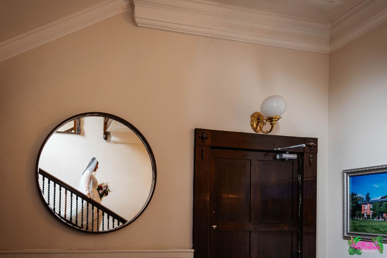 A reflection of a bride in a mirror walking down the stairs at Bartle Hall before she walks down the aisle