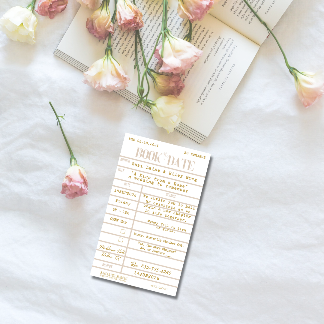 Pink carnation flowers and paper cards arranged on a white surface with open book pages for wedding invitation styling.