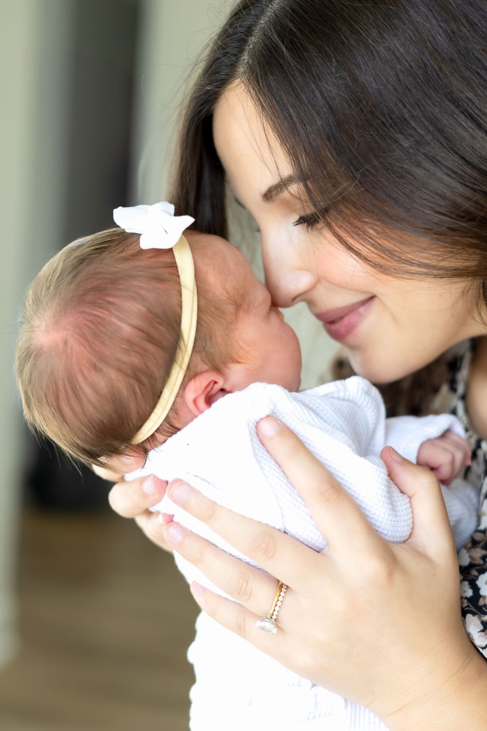 Mom touches noses with new baby daughter during newborn session in Athens, GA.