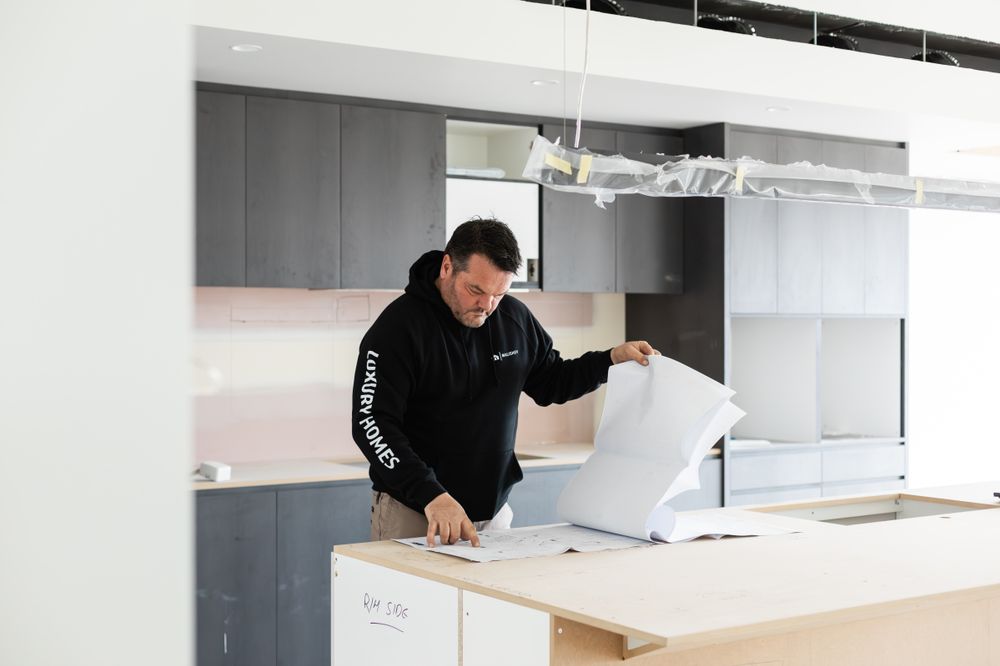 Interior construction progress showing workspace with building materials and tools.