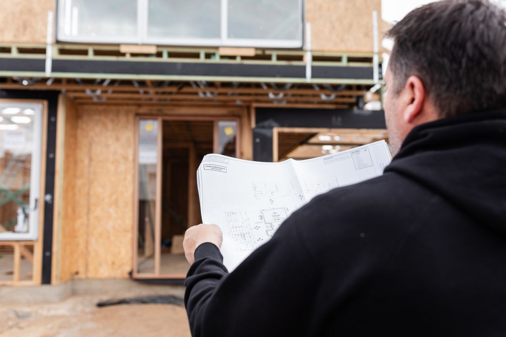 Construction site inspection showing wooden framing and support beams in a residential build.
