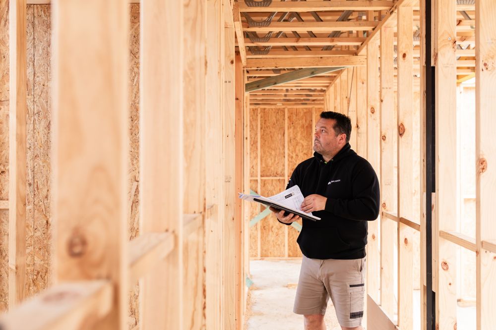 Interior walkthrough of new home construction with exposed wooden framing and beams.