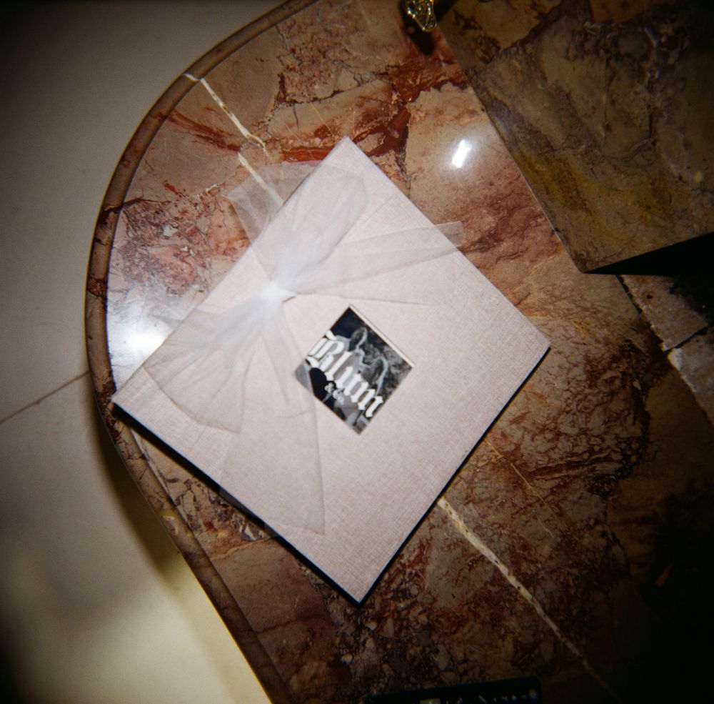 Elegant wedding invitation on marble table viewed from above.