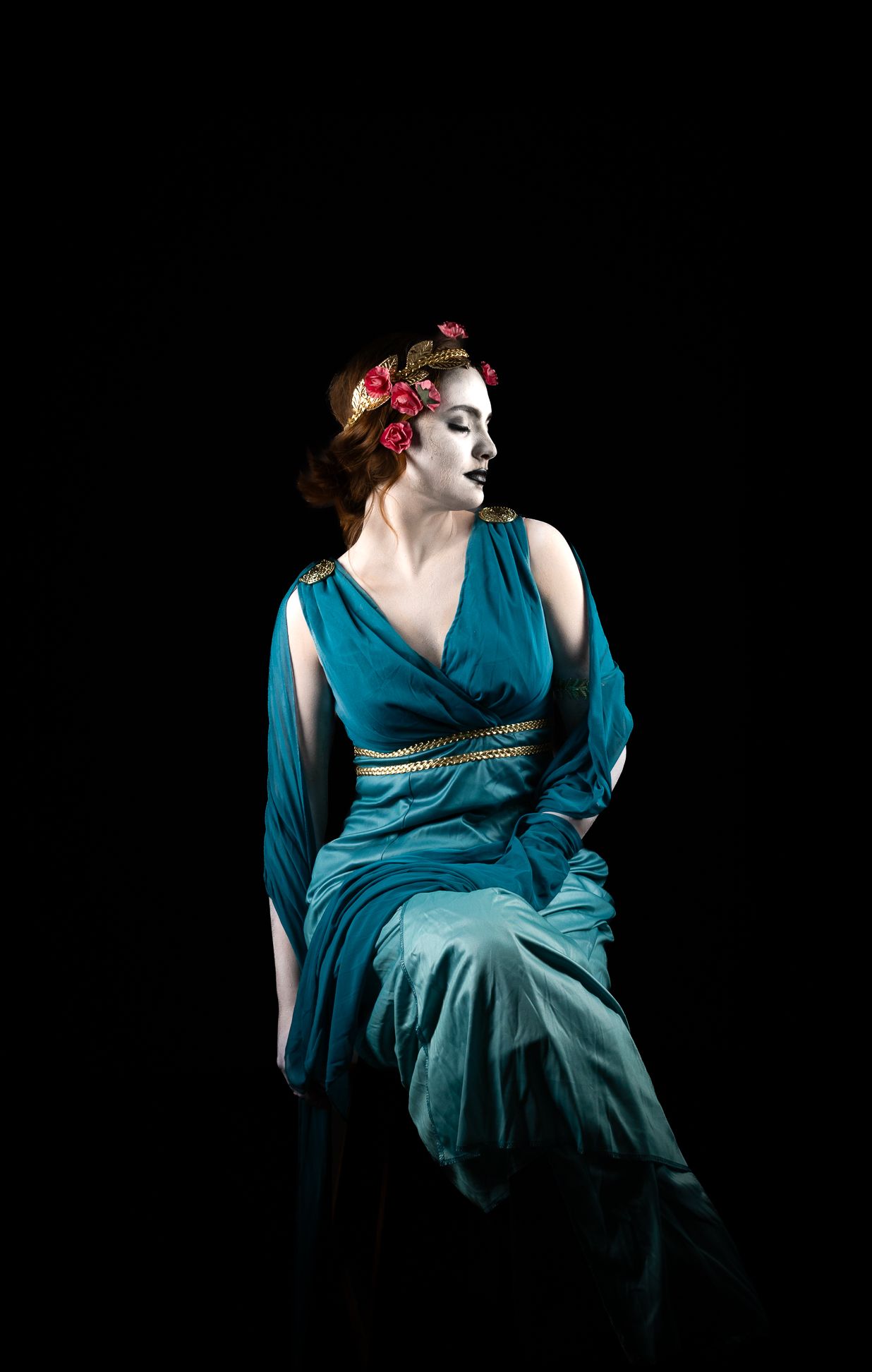 Woman dressed as a Greek Goddess, with makeup to make her look like a Greek statue
