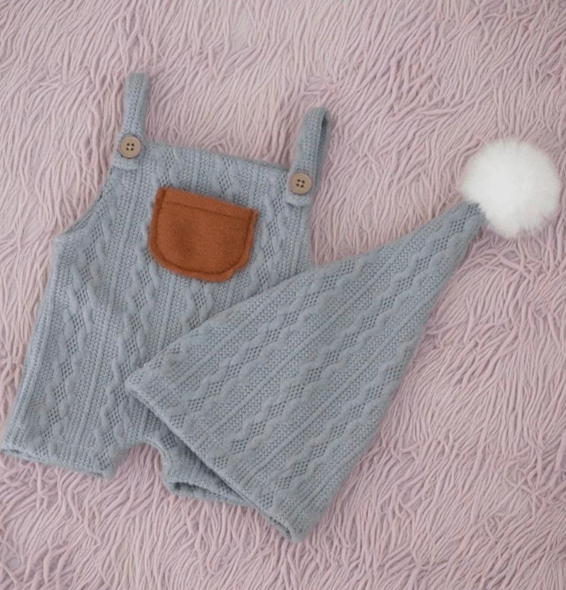 Quilted pink baby romper with buttons and matching pom pom hat.