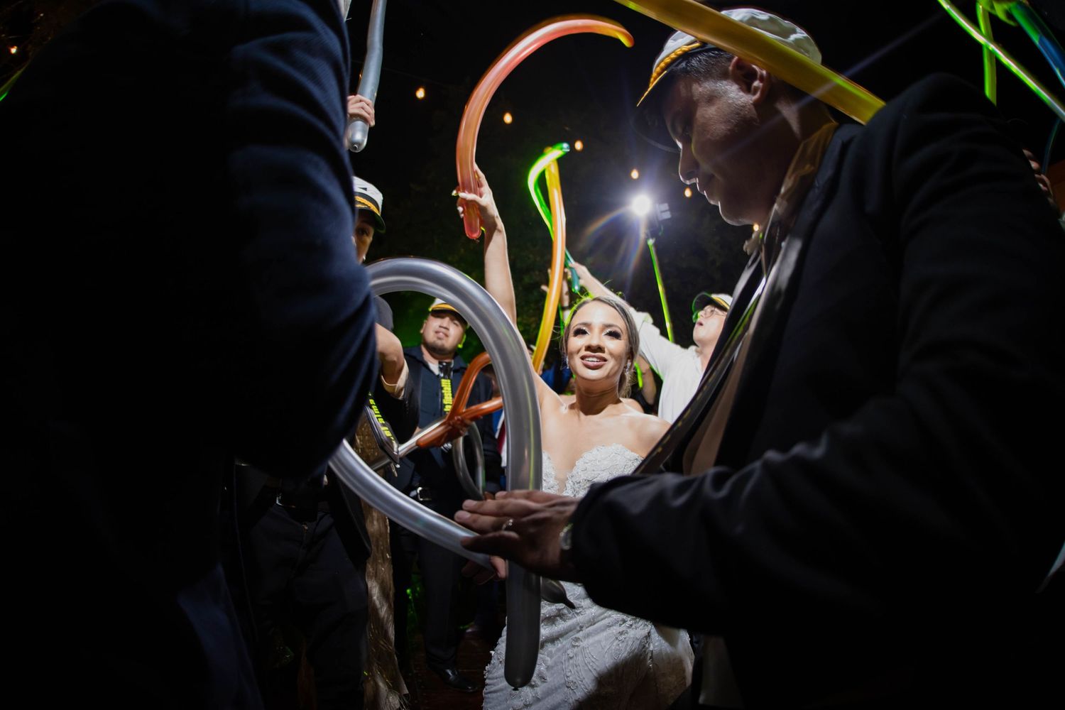 Artistic nighttime wedding photo with light trails and creative composition.