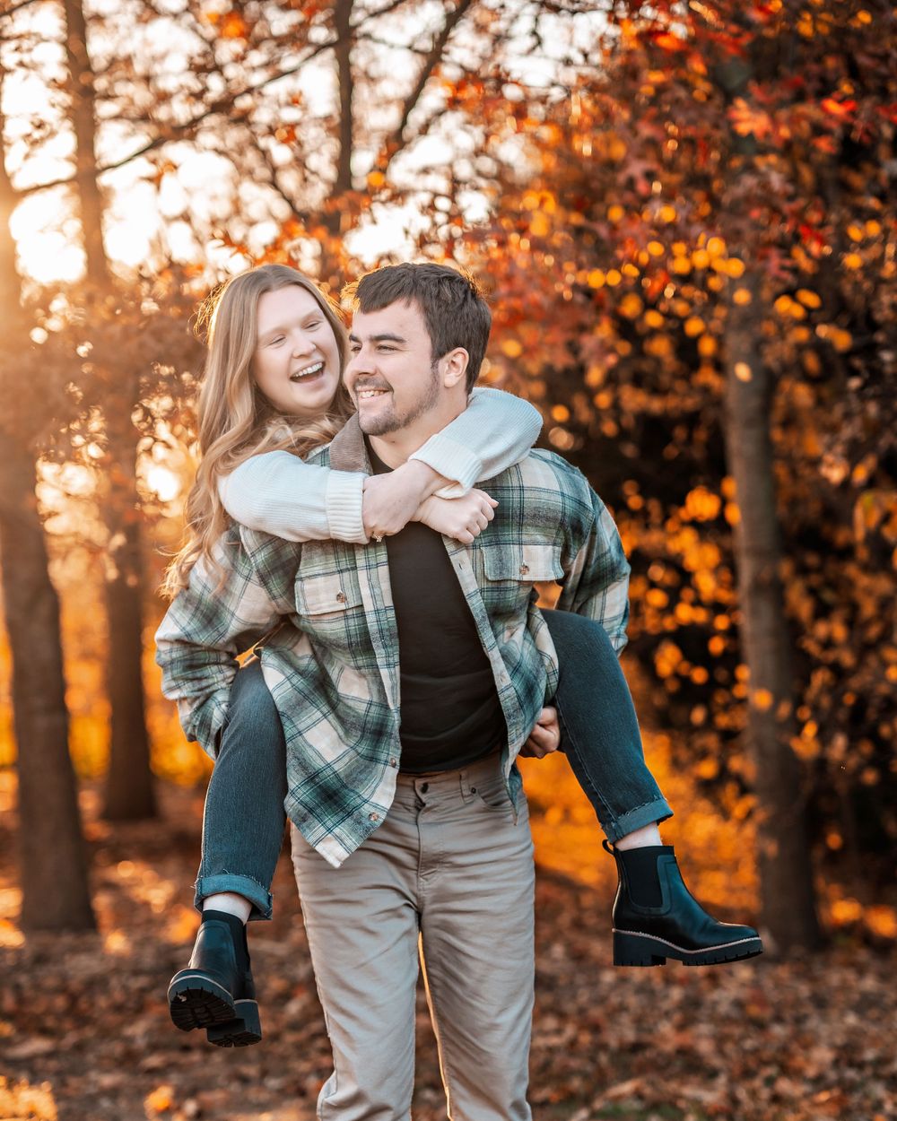 Playful piggyback ride during golden hour with autumn trees in background.