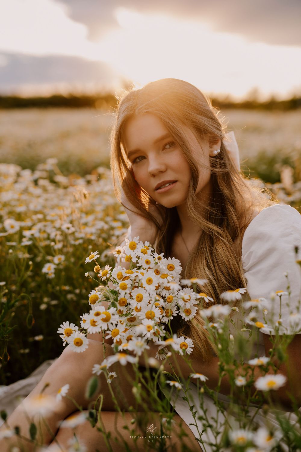 Portrait among blooming daisies during golden hour in a meadow.