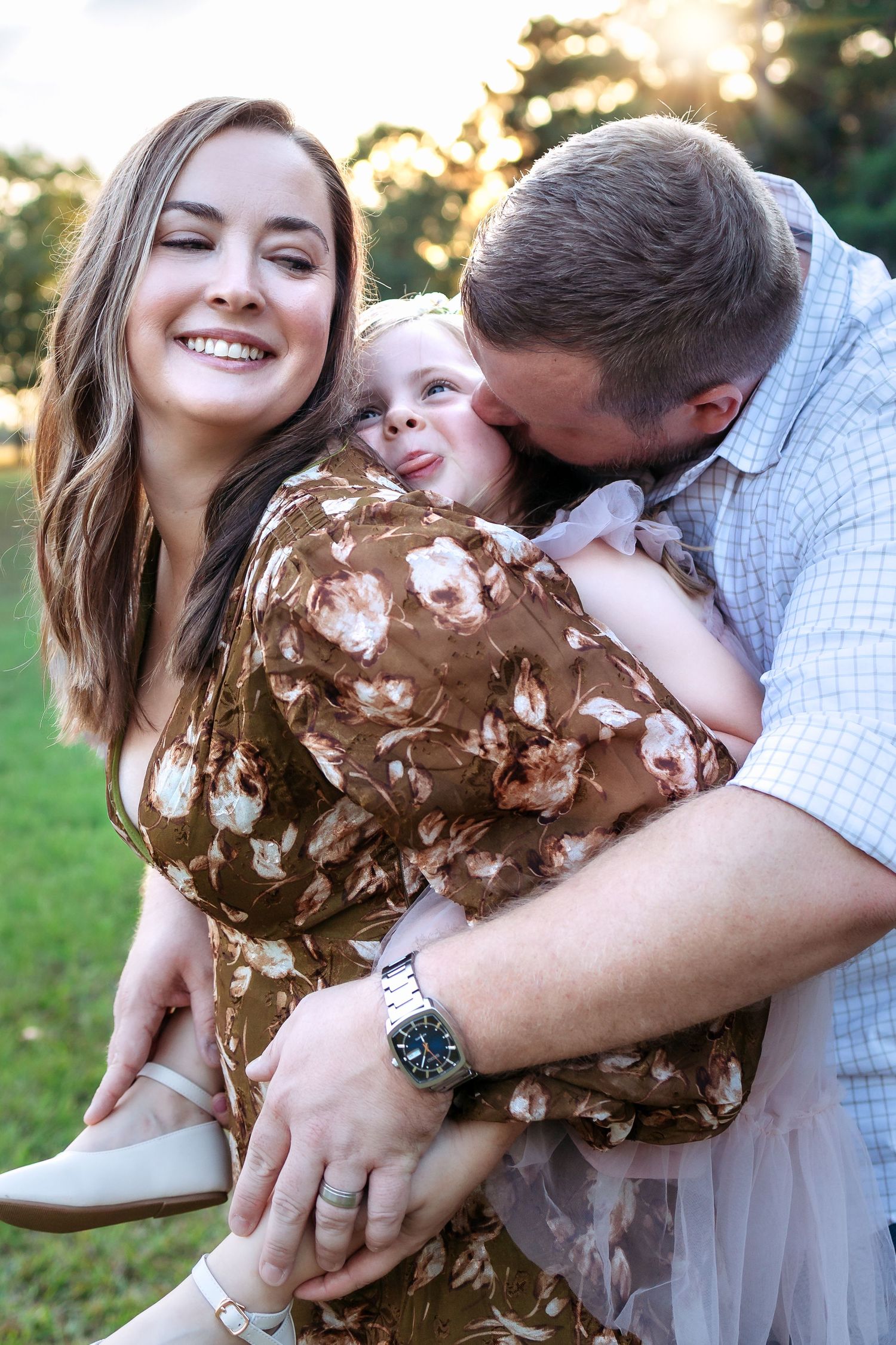 Beautiful family of four in a field of tall grass with the sun peaking through during a family mini session - Athens, GA family photographer