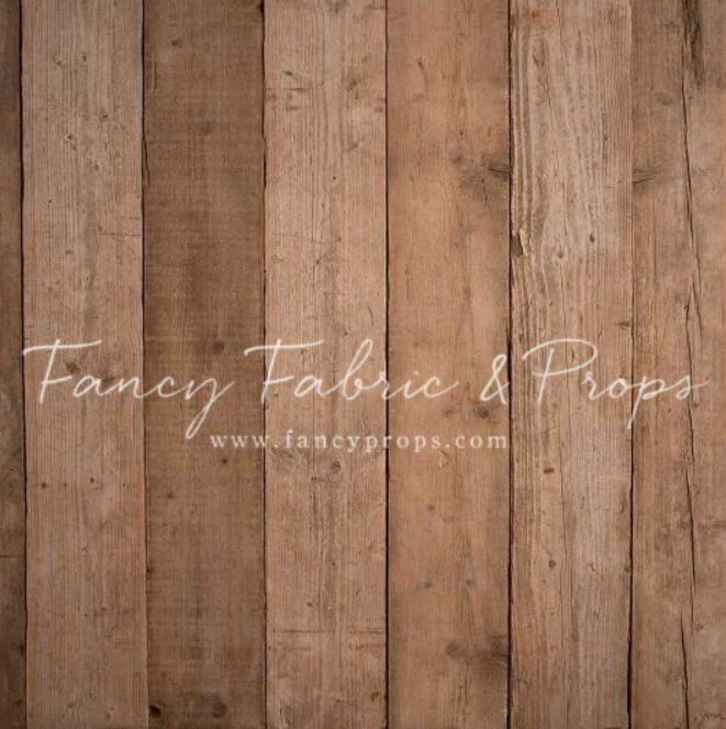 Rustic brown vertical wood plank backdrop with natural grain texture, ideal for photography by Fancy Fabric & Props.