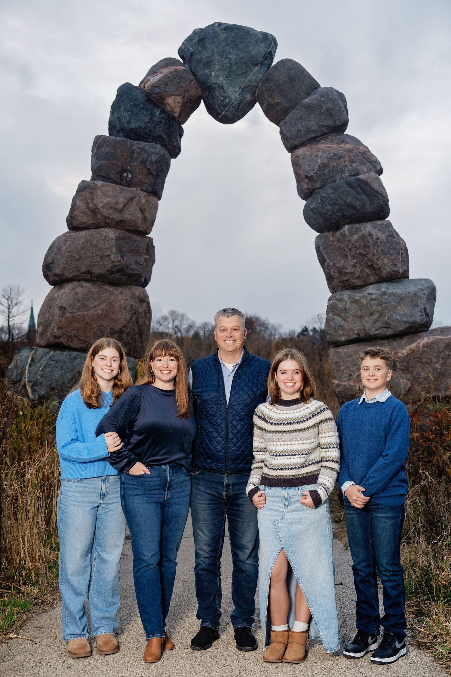 Photo of a family in front of a stone arch taken by Milwaukee family photographer Rachel Dickman.