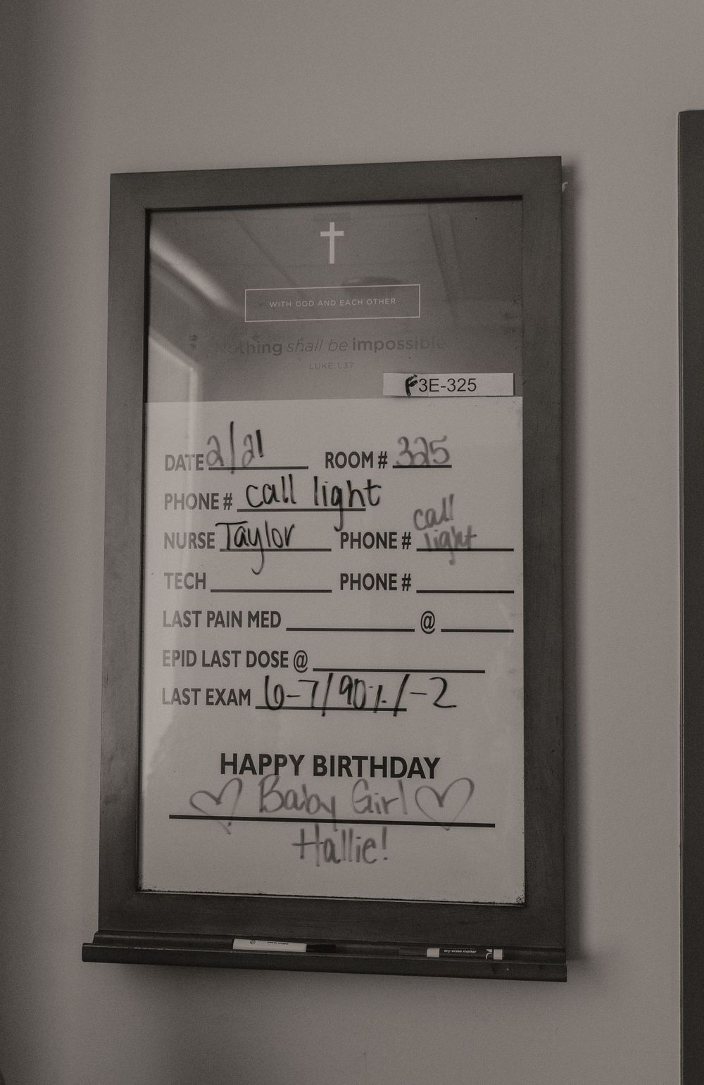 Hospital room whiteboard showing birthday message and patient details in black and white.
