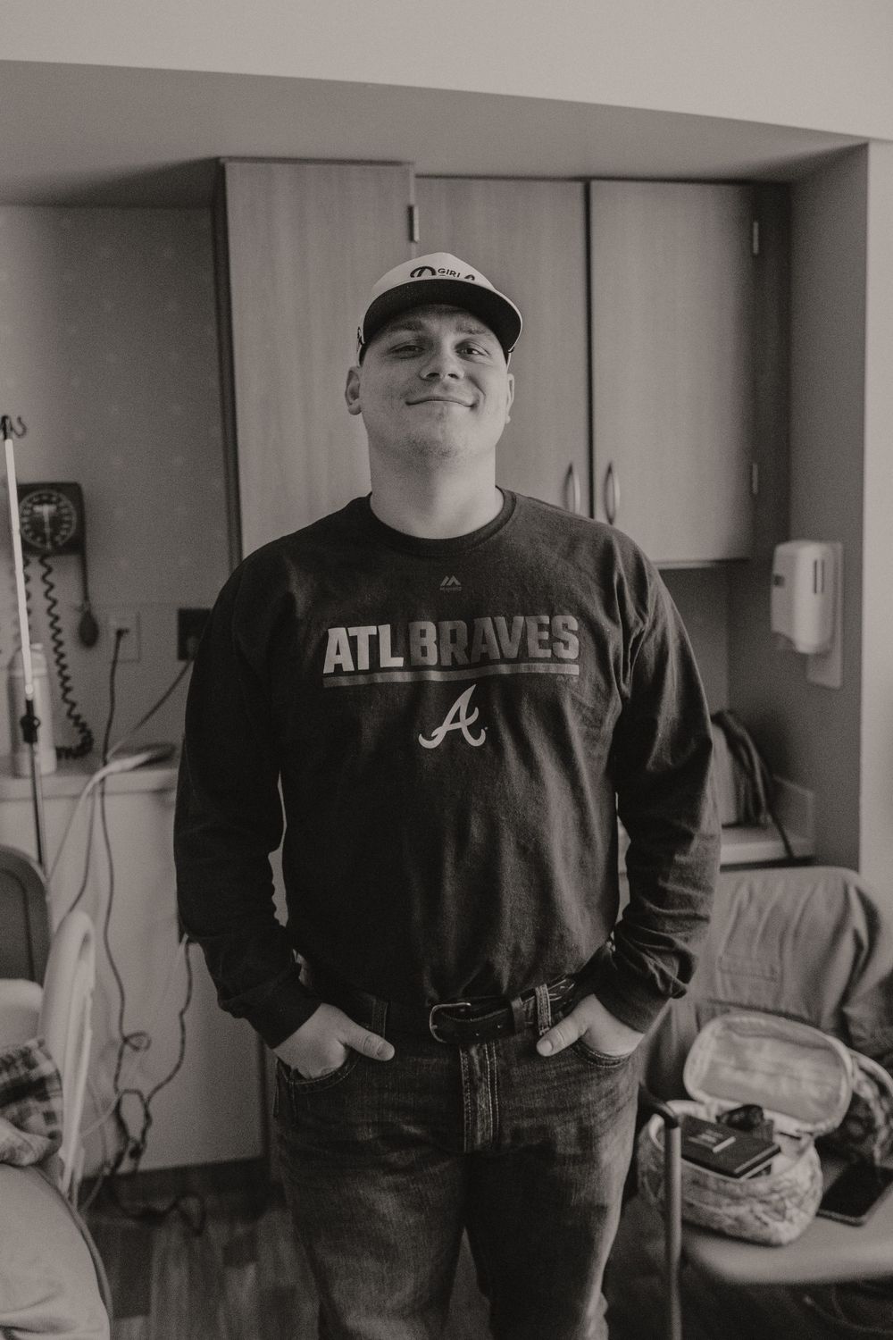 Person wearing Atlanta Braves apparel in a hospital room.