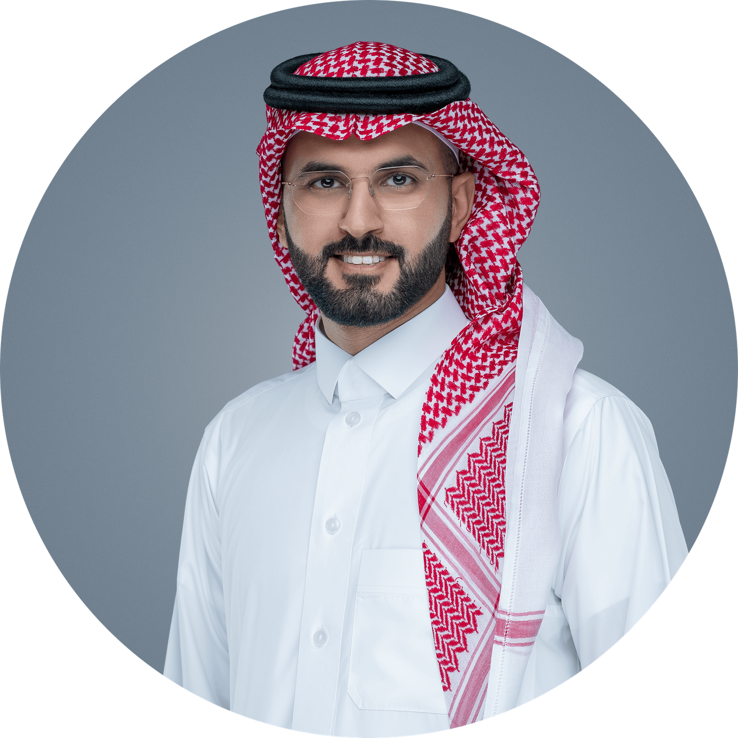 Professional portrait of a person wearing traditional Middle Eastern dress including white thobe and red and white keffiyeh.