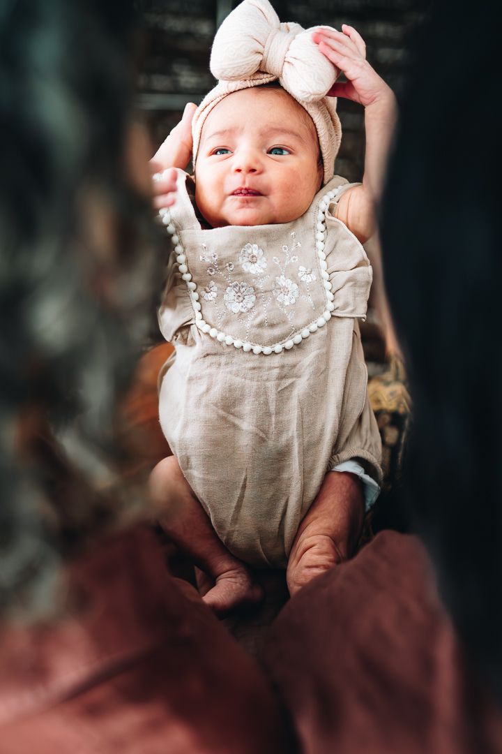 Newborn baby looking lovingly at her dad during a newborn photoshoot at home by Melbourne newborn and family photographer Pei A Photography
