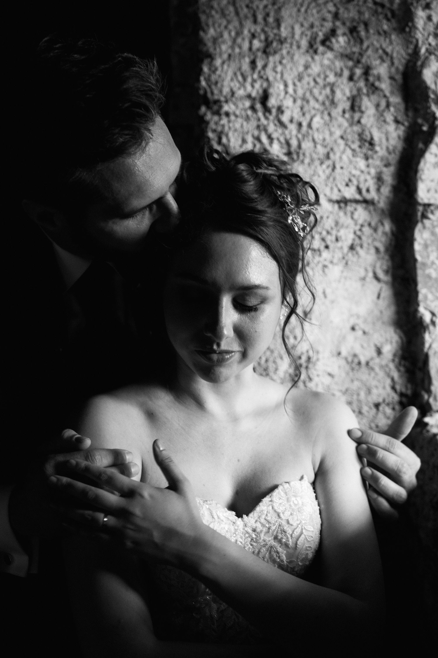Two hands reaching toward each other tenderly against a blurred natural background.