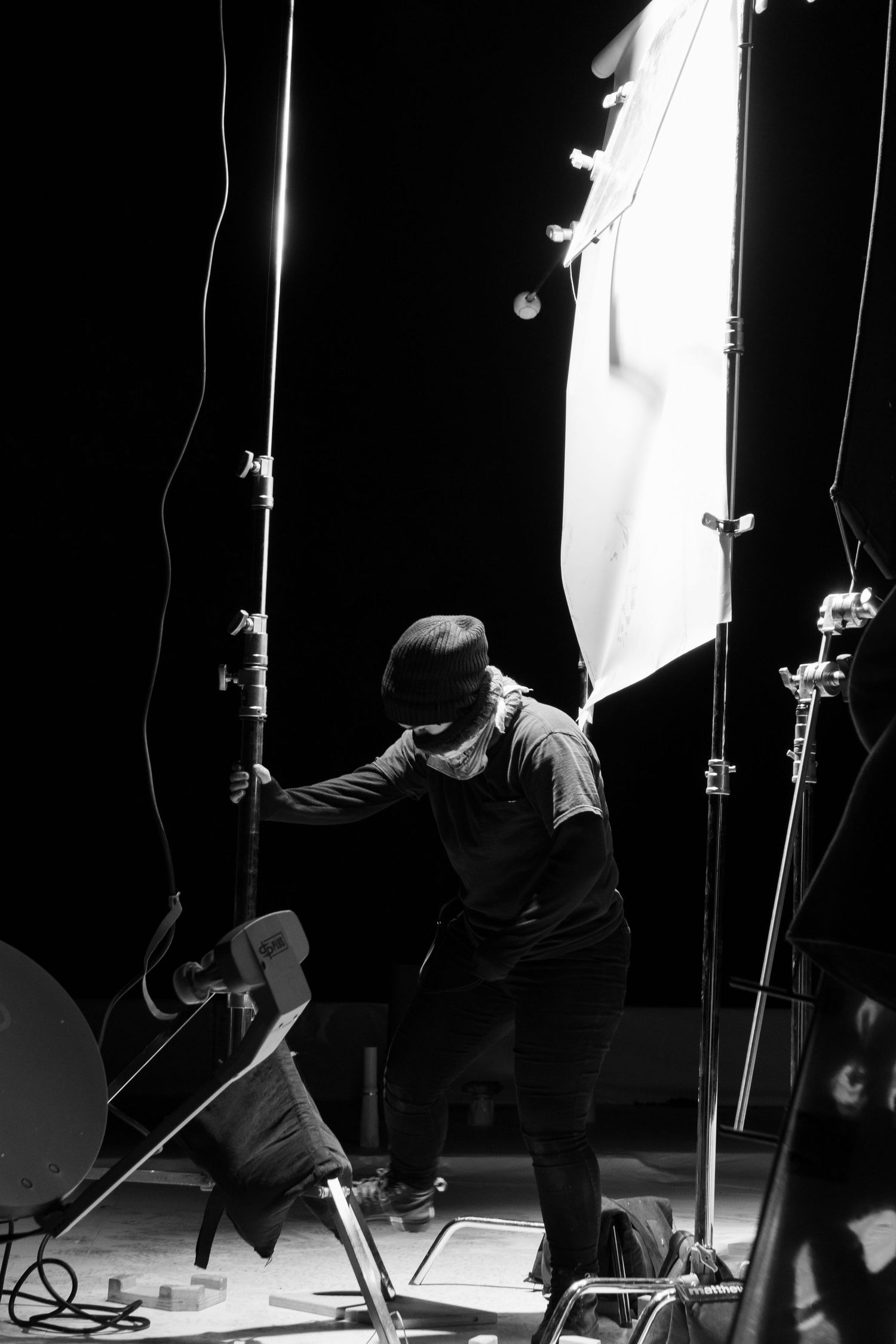 A film crew member rigging up film light
