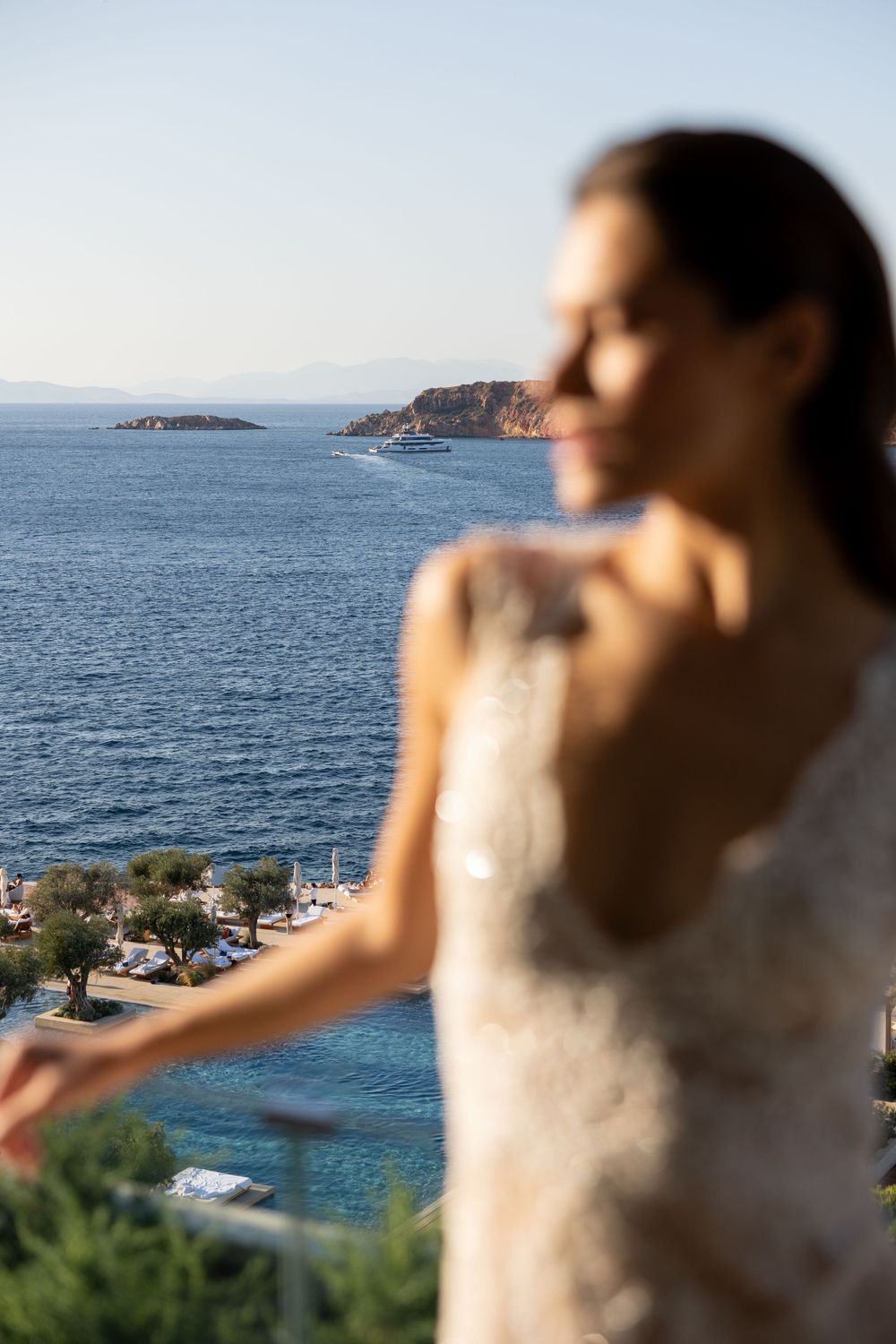 A scenic Mediterranean coastline view with blue waters and rocky islands, captured from an elevated seaside vantage point.