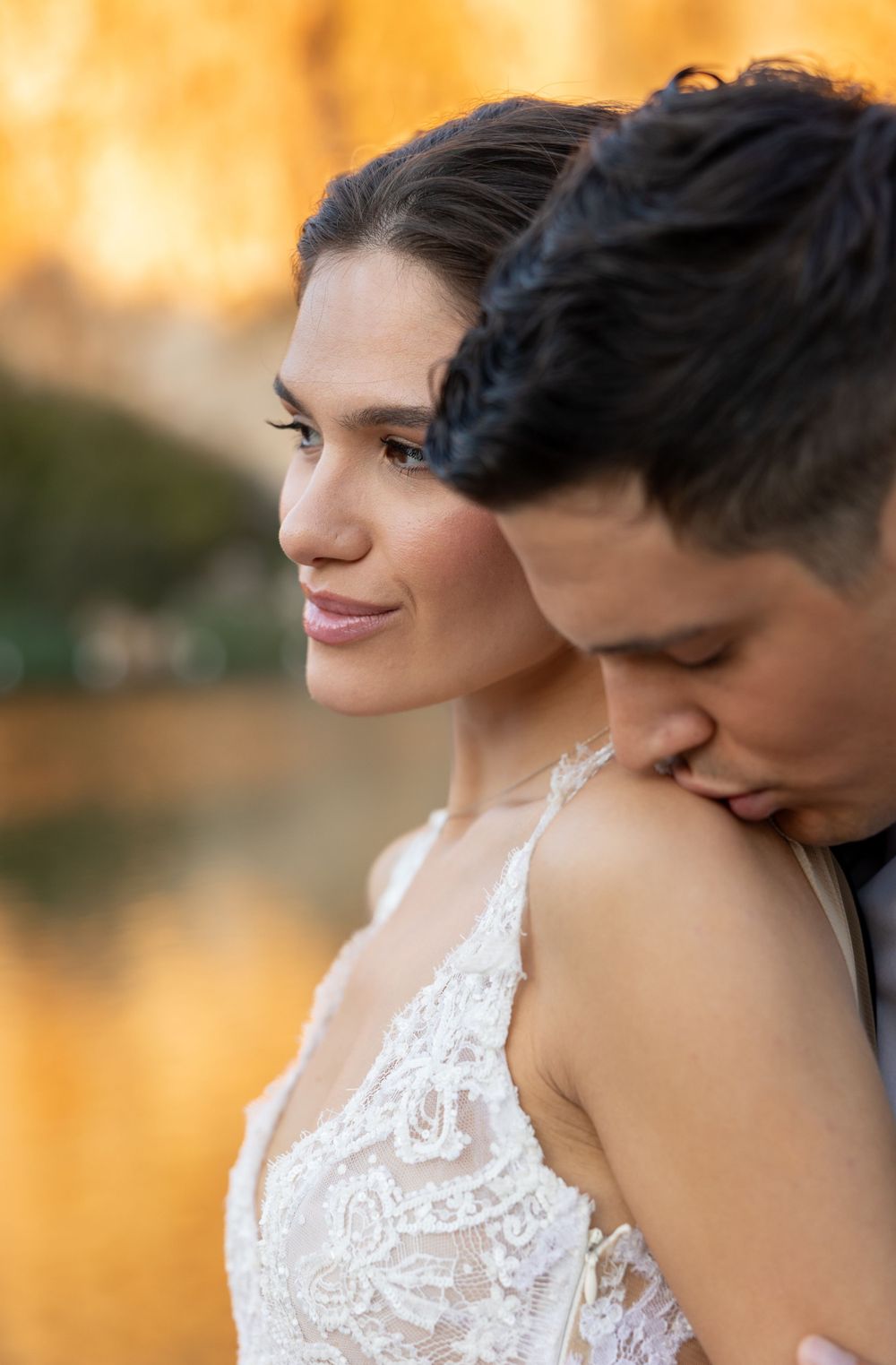 A romantic wedding couple shares an intimate moment during golden hour.
