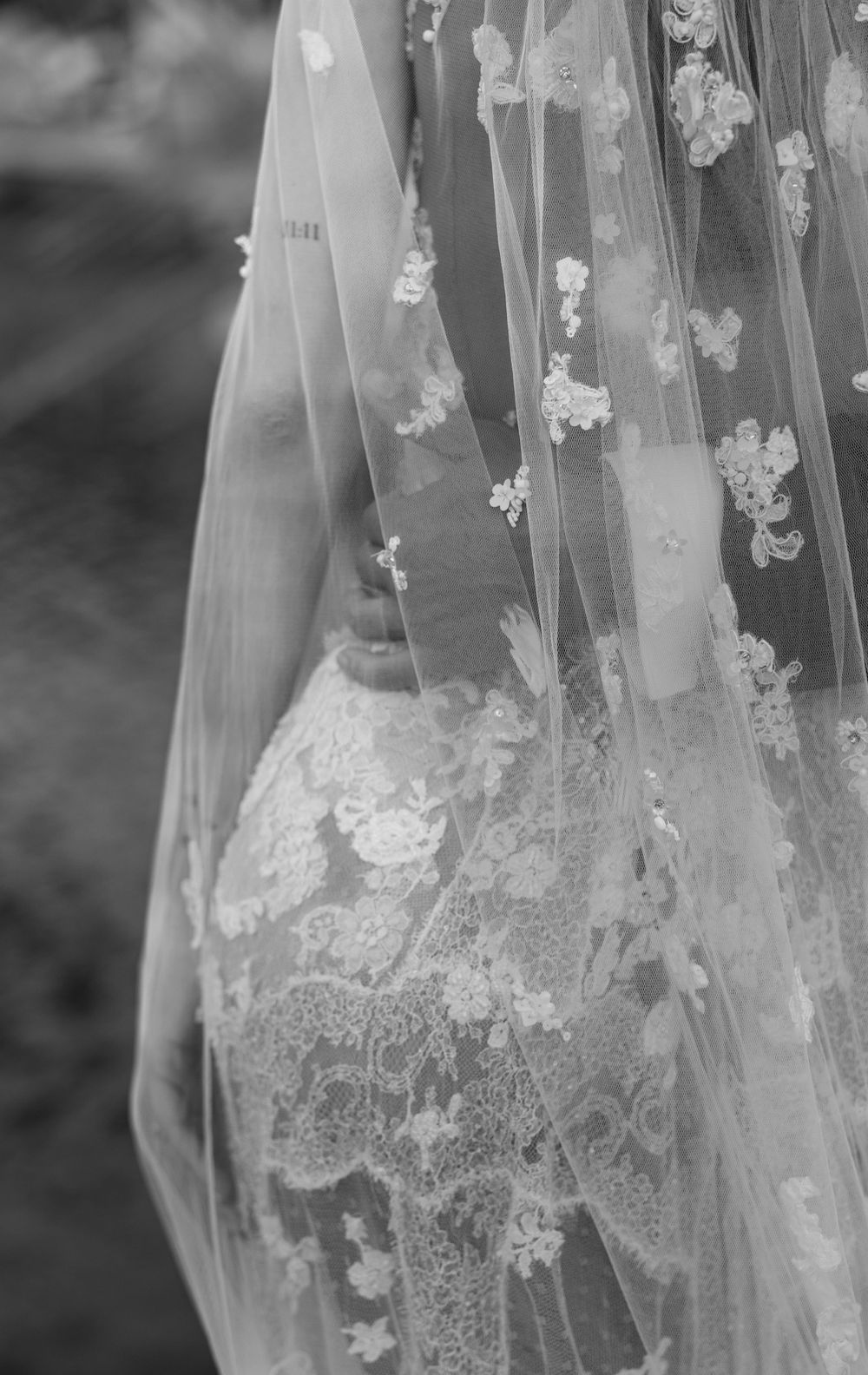 Delicate floral lace veil with intricate embroidered details in black and white.