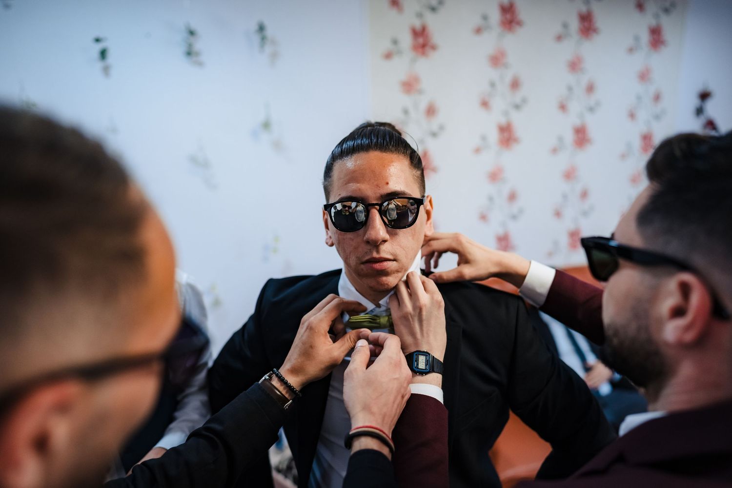 Wedding party members wearing sunglasses and formal attire during celebration.
