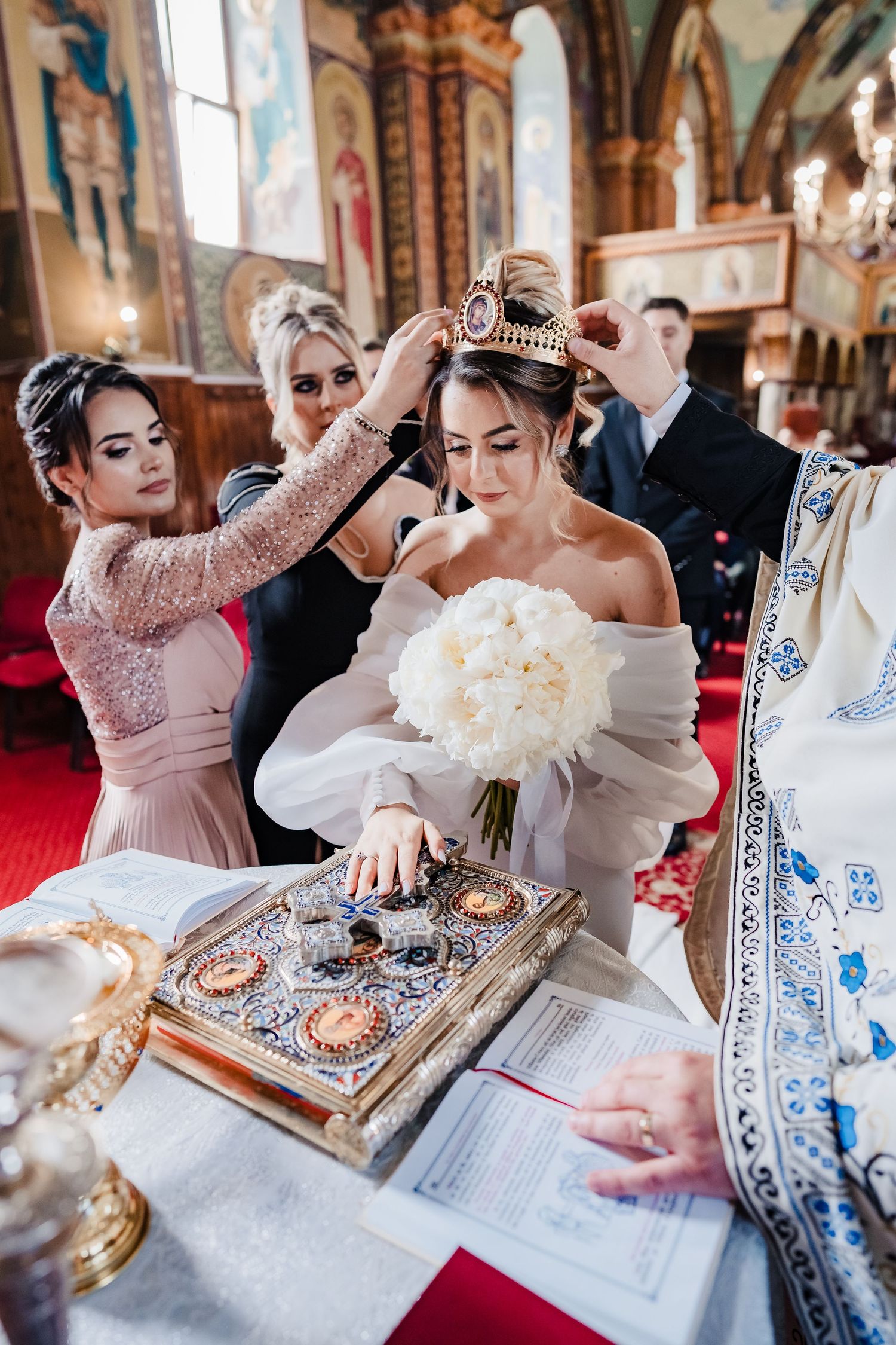 Traditional wedding ceremony with religious texts and decorative elements on altar.