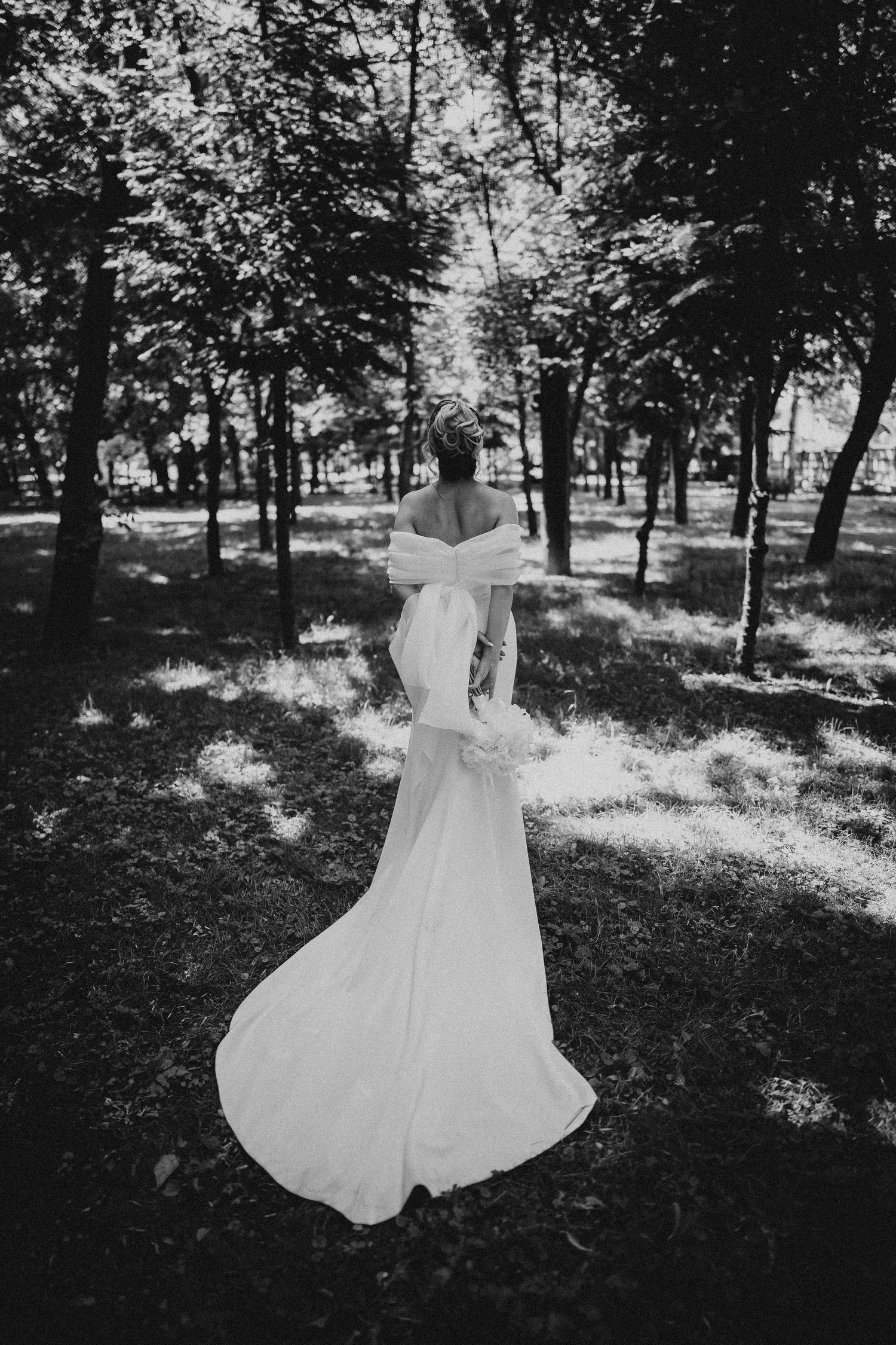 Black and white wedding portraits showing romantic moments in a wooded setting.